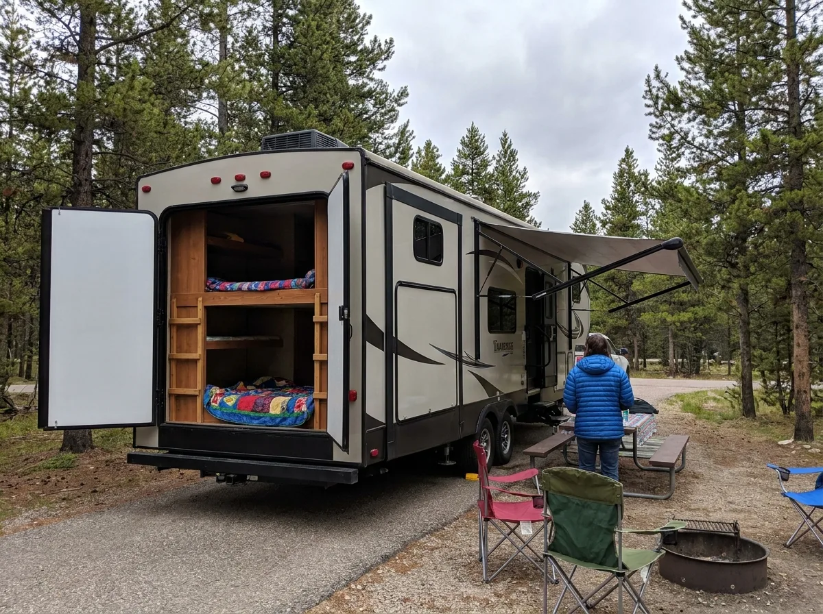 Family trailer with bunk beds parked at campsite during daytime