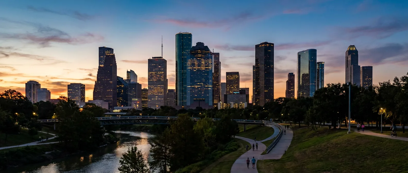 Houston downtown skyline at dusk reflected in Buffalo Bayou park with warm natural lighting